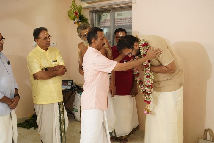 A garland being placed on a family member